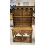 20th cent. Oak dresser the rack with shaped cornice above two shelves, the base with two drawers