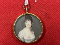 French School: Early 19th cent. Miniature, a lady in a yellow metal frame. Dia. 1?ins. Ivory