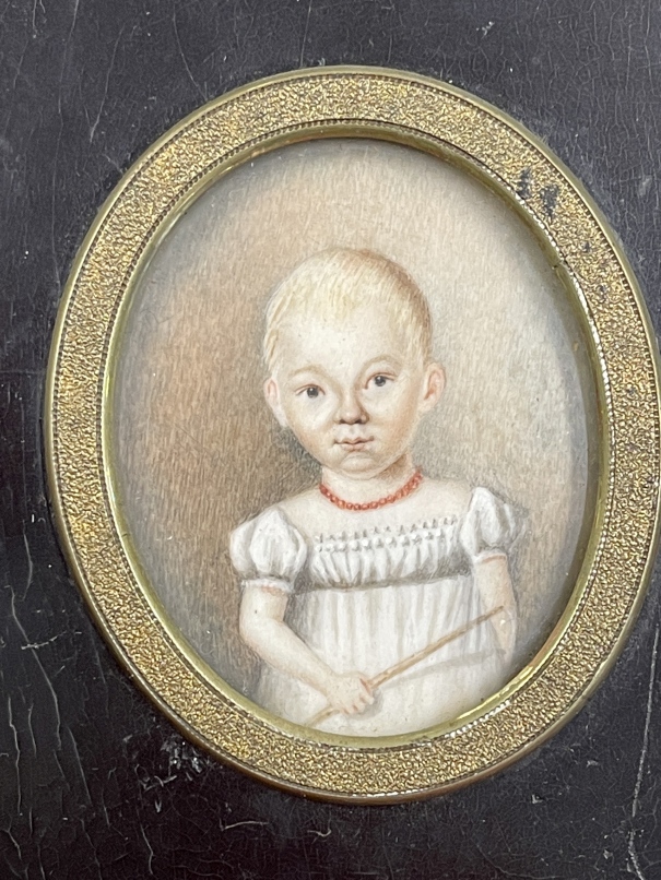 English School: 19th cent. Oval miniature, a child in a white dress in an ebonised frame. 2½ins. x