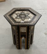 Early 20th cent. Islamic table of hexagonal form inlaid with mother of pearl, ebony and teak. 20ins.