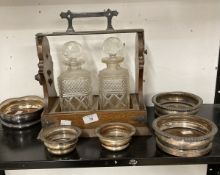 Late 19th cent. Oak and silver plated Tantalus containing two decanters, one damaged, a small pair