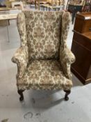 19th cent. Paisley upholstered high wing back chair, front pad feet sloping rear supports. Height