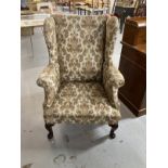 19th cent. Paisley upholstered high wing back chair, front pad feet sloping rear supports. Height