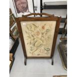 Early 20th cent. Mahogany fire screen with panel of crewel work embroidery. 29ins. x 23ins.