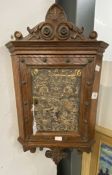 19th cent. Small oak wall hung corner cabinet with carved scrollwork to top and bottom, door