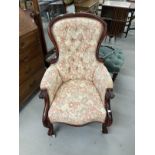 19th cent. Button back upholstered library armchair, carved scroll arms and cabriole legs. 27ins.