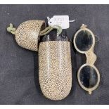 18th/19th cent. Ophthalmic: Horn folding tinted glasses, one arm A/F enclosed in a shagreen case.