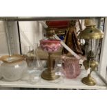 Lighting: Brass round base oil lamp, round column, pink glass reservoir with painted swags and