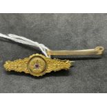 Hallmarked Gold: Two 25ct bar brooches, one plain and one set with a single ruby and eight rose