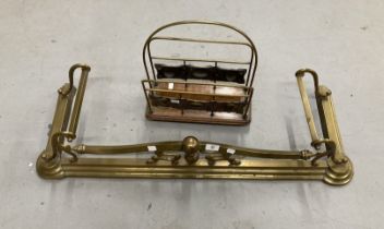 Art nouveau brass fender and an early 20th cent. brass & oak magazine rack.