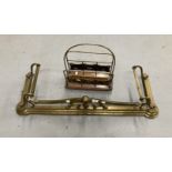 Art nouveau brass fender and an early 20th cent. brass & oak magazine rack.