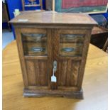 Early 20th cent. Oak smokers/collectors cabinet. 17ins. x 14ins. x 8½ins.