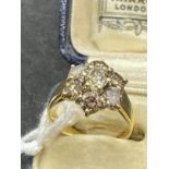 Jewellery: Yellow metal ring set with seven brilliant cut champagne colour diamonds, estimated