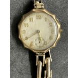 Watches: Yellow metal ladies wristwatch, round dial with Arabic numerals attached to a yellow