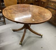 Regency mahogany oval breakfast table on single column and four splayed supports. 52ins.