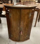 18th cent. Oak bow front hanging corner cupboard dentil cornice above 2 doors on a moulded base, the