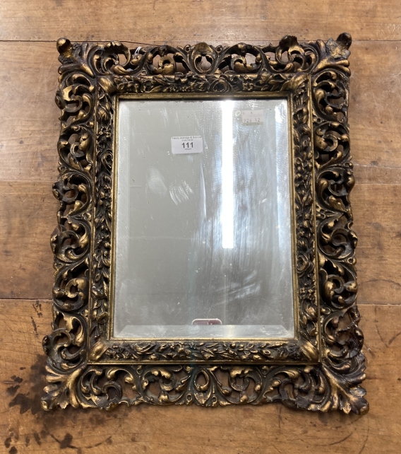 20th cent. Gilt gesso moulded mirror with bevelled glass. 18ins. x 14ins.