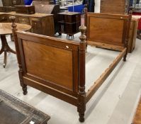 Late 19th/early 20th cent. Mahogany bed with square moulded panels flanked by turned columns, slight