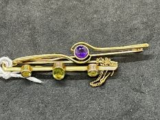 Jewellery: Yellow metal two bar brooches, one set with amethyst, the other with peridot, both test