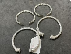 Jewellery: White metal tests as silver Etrusan style bangles with dog heads and a pair of child's