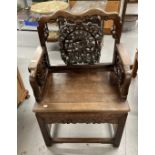 19th cent. Chinese hardwood armchair, the back with shaped top rail, central carved panel of lion