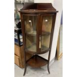 Edwardian bow front corner display cabinet. The top with a gallery, the 2 doors with checkered inlay