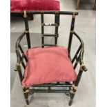 Mid 20th cent. Green painted cane armchair, shaped arms, ladder back with cushion seat.
