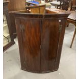 Late 18th cent. Mahogany bow front corner cupboard, moulded cornice above two doors flanked by