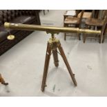 20th cent. Brass floor standing telescope on a treen and brass stand. Length 38ins.