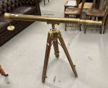 20th cent. Brass floor standing telescope on a treen and brass stand. Length 38ins.