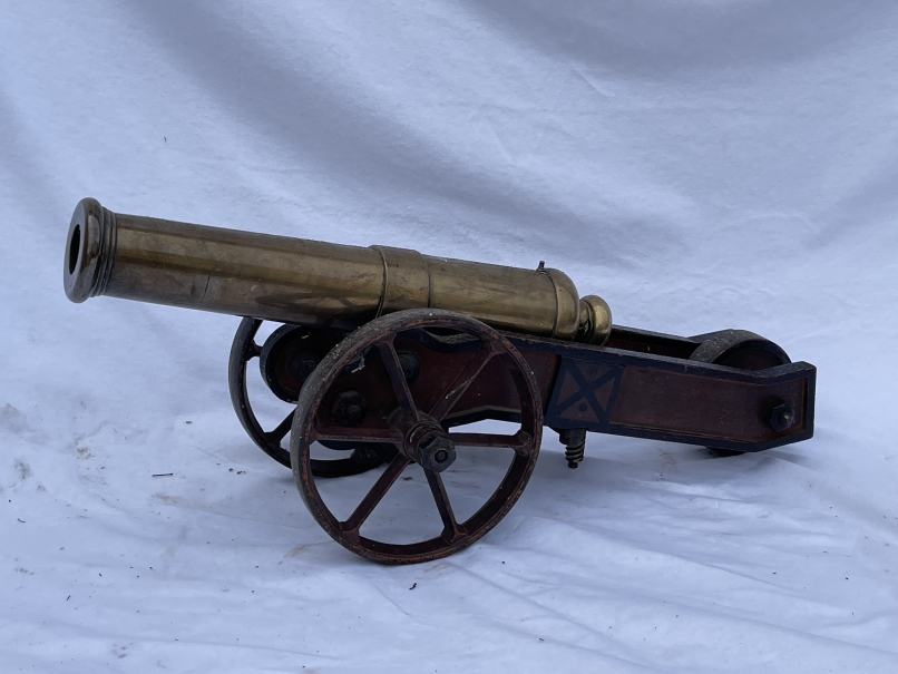 MILITARIA: A mid-19th century brass signal cannon, with cylindrical barrel on a shaped truckle base,