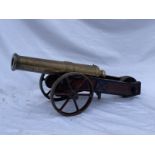 MILITARIA: A mid-19th century brass signal cannon, with cylindrical barrel on a shaped truckle base,