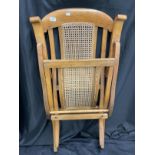 Early 20th century folding steamer chair with rattan seat and back.