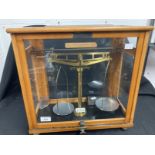 Scientific Instruments: 19th cent. Laboratory scales in glazed beech cabinet, with weights,