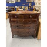 19th cent. Mahogany bow front chest of drawers on bracket feet with shaped front apron, turned
