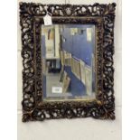 20th cent. Gilt gesso moulded mirror with bevelled glass. 18ins. x 14ins.