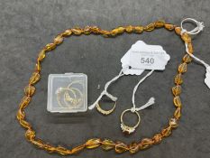 Jewellery: Necklet of amber beads, length 22ins, silver dress ring, weight 2.4g. Yellow metal ring