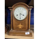 Clocks: Edwardian mahogany mantel clock arched top, columns to the sides with an inlaid urn to the