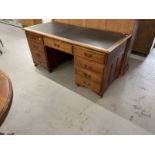 Edwardian mahogany stained nine drawer twin pedestal desk with brass drop handles. Approx. 66ins.