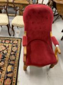 19th cent. Walnut button back nursing chair rising off ceramic castors.