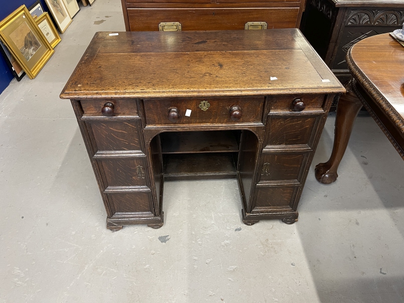 19th cent. Oak kneehole desk, three drawers across the top, with a door either side revealing