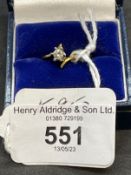 Jewellery: Yellow metal cross over set with a single brilliant cut diamond, estimated weight of 0.