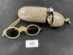 18th/19th cent. Ophthalmic: Horn folding tinted glasses, one arm A/F enclosed in a shagreen case.