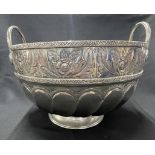 White metal Middle Eastern twin handle punch bowl with heavily embossed and engraved foliate band