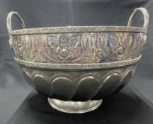 White metal Middle Eastern twin handle punch bowl with heavily embossed and engraved foliate band