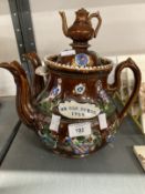 20th cent. Ceramics: Treacle barge ware, possibly Rockingham, double spout teapot with lid and