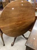 19th cent. Mahogany tilt top dining table on gin barrel supports, tripod club feet.