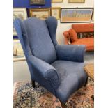 20th cent. Blue upholstered wingback armchair on square tapering front legs supported on brass