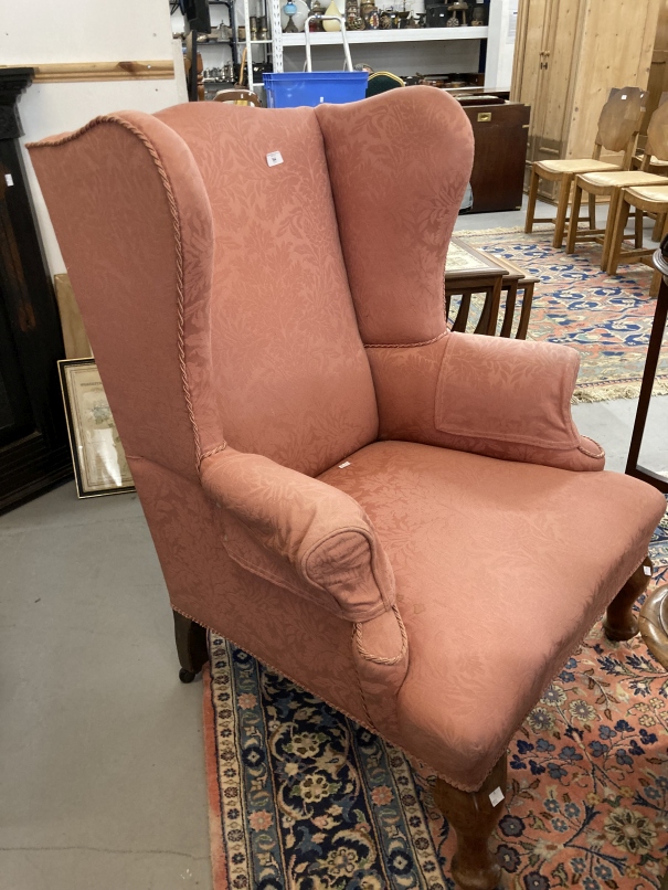 20th cent. Pink upholstered wingback armchair on cabriole legs.