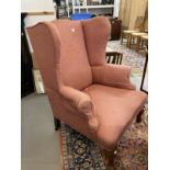 20th cent. Pink upholstered wingback armchair on cabriole legs.